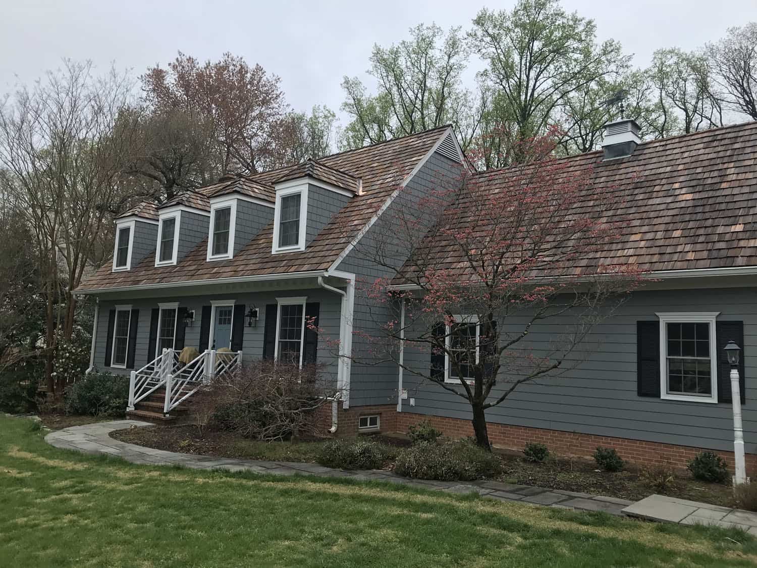 A house with a red tile roof and white trim.